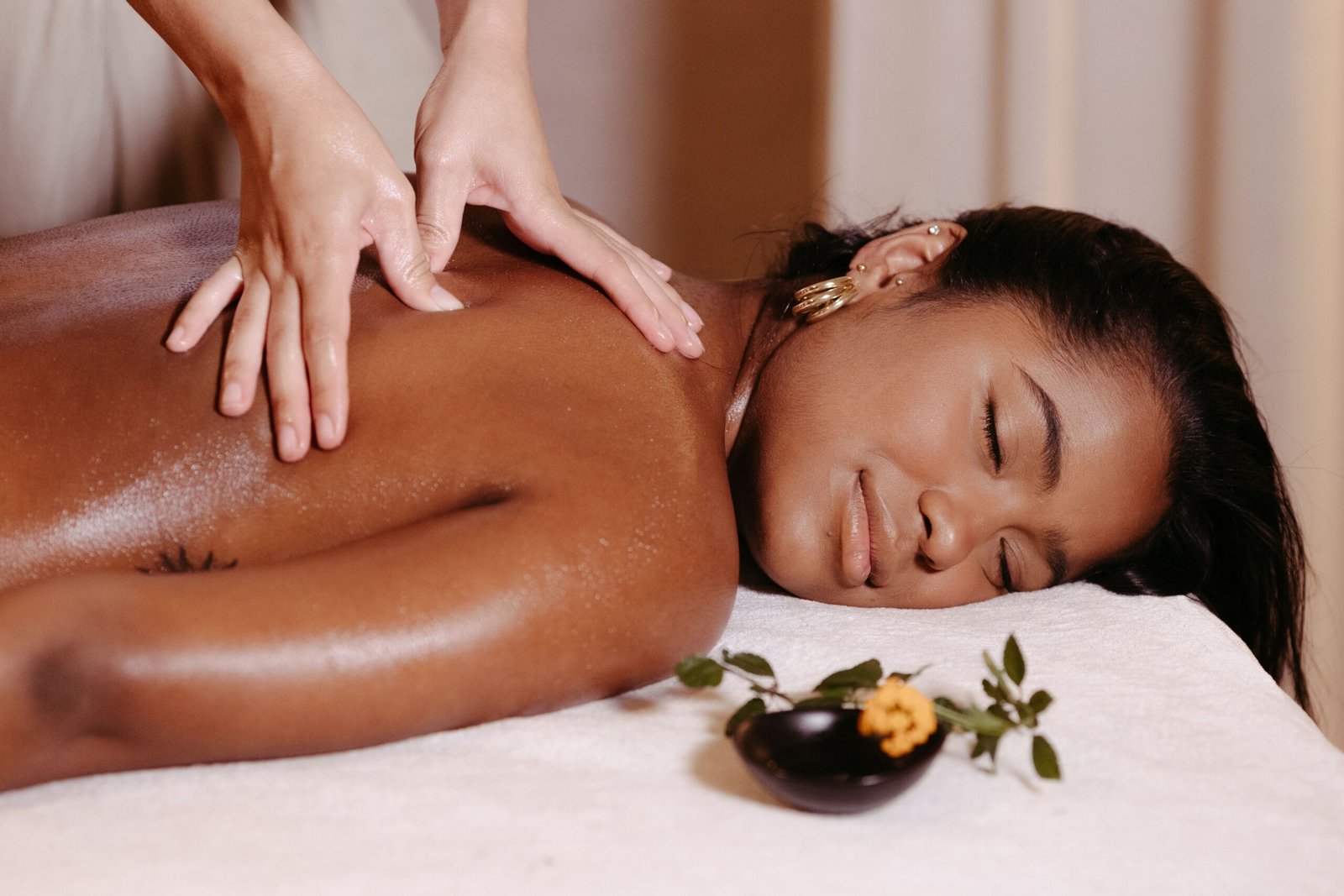 A woman enjoys a therapeutic massage, promoting relaxation and well-being.