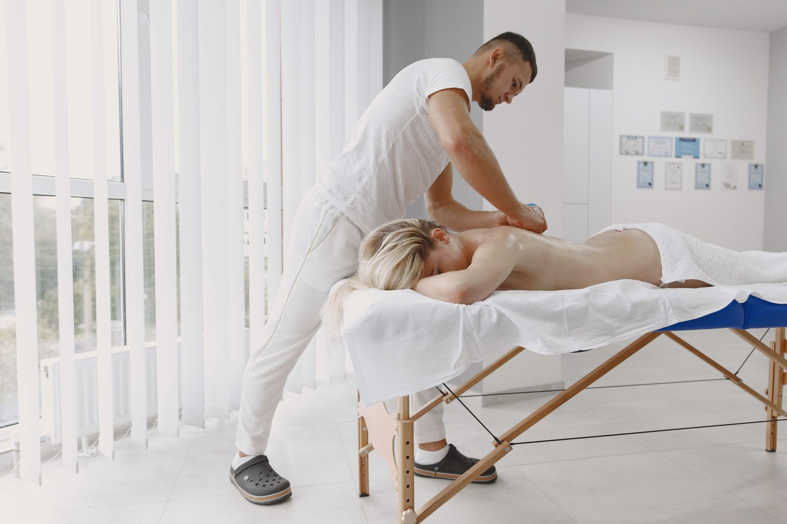 A relaxing full-body massage session taking place in a serene, modern spa environment.