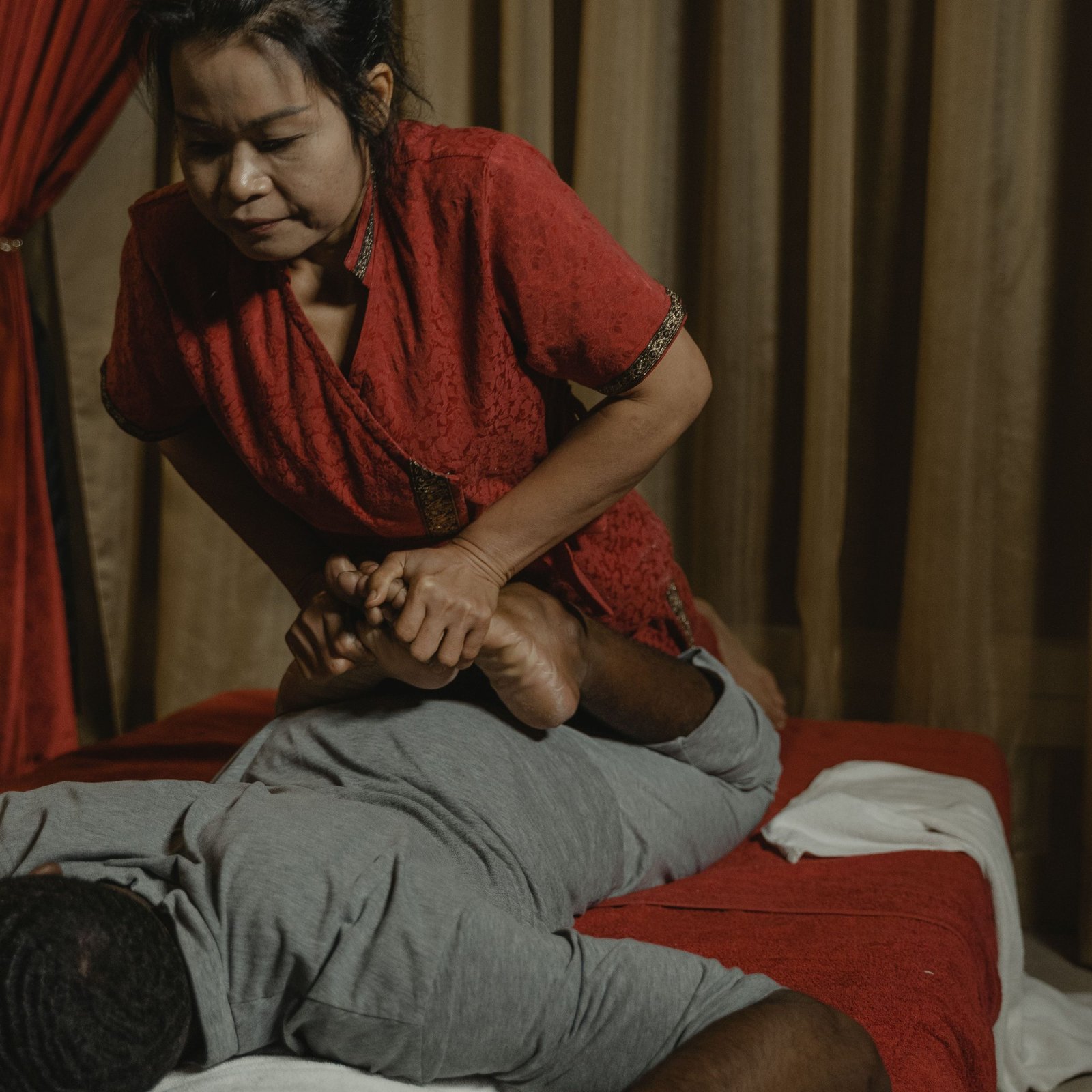 A soothing Thai massage in a tranquil room with an experienced therapist providing care.