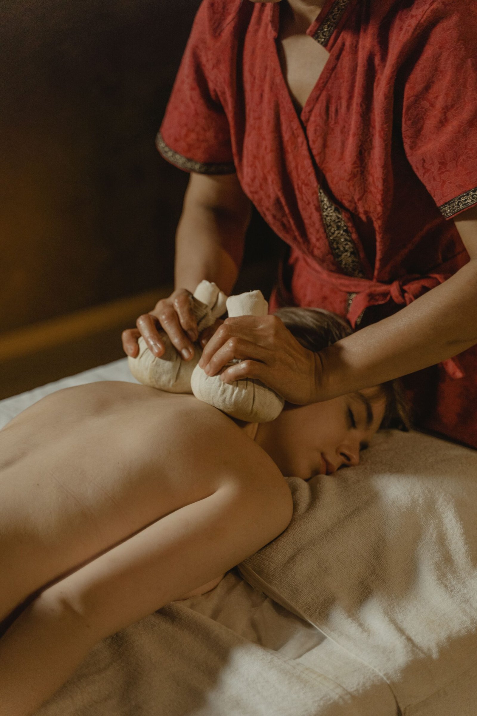 A soothing massage with herbal compresses provides relaxation and wellness benefits.
